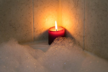 Candle Burning By Bubble Bath Candle Burning By Bubble Bath