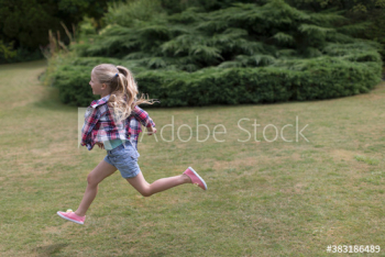 Carefree girl running in grass