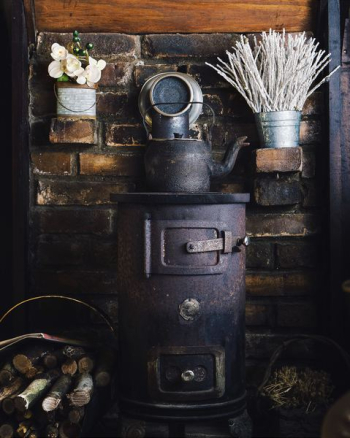 cast-iron teapot on wood burner cast-iron teapot on wood burner