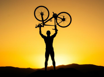 Celebrating Victory: Silhouette of a Cyclist at Sunset Celebrating Victory: Silhouette of a Cyclist at Sunset