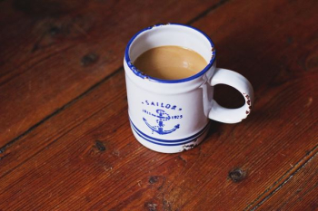 ceramic mug filled with brown liquid ceramic mug filled with brown liquid