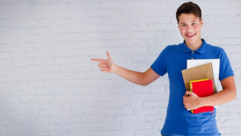 Cheerful teenager pointing left Cheerful teenager pointing left
