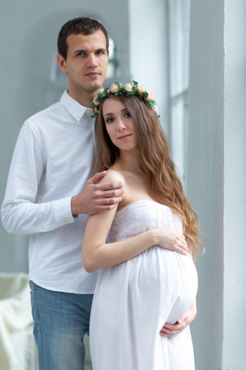 Cheerful young couple  dressed in white standing at home Free Photo