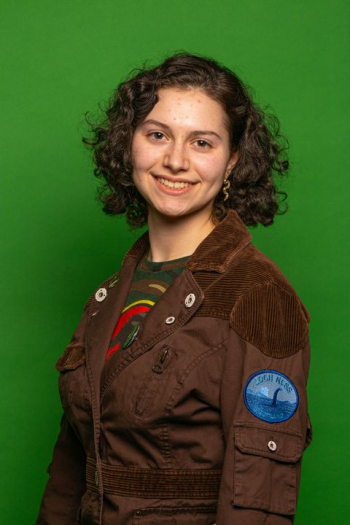 Cheerful Young Woman in Casual Brown Jacket with Green Background Cheerful Young Woman in Casual Brown Jacket with Green Background