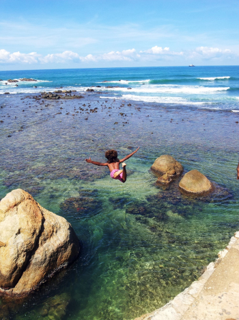 Child Diving Off Cliff Into Sea Child Diving Off Cliff Into Sea