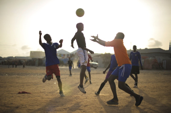 Children play football next to an | Free Photo - rawpixel