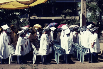 Children Wearing White Academic Gown during Graduation Ceremony at Daytime