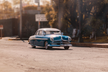 Classic Blue Car on Road Classic Blue Car on Road