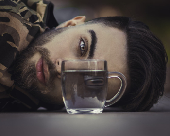 Clear Glass Cup In Front Of Man Clear Glass Cup In Front Of Man