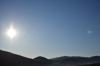 Clear Sky And Glaring Sun Over Hillside Clear Sky And Glaring Sun Over Hillside