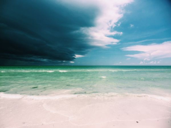 clear white sand beach under cloudy sky clear white sand beach under cloudy sky
