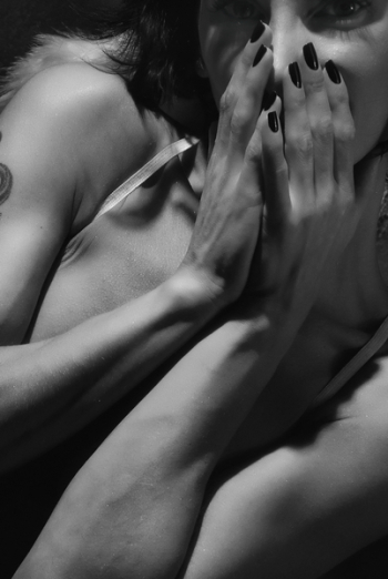 Close-up and Grayscale Photo of Woman Covering Her Mouth
