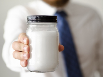 Close-up hand holding a jar of sugar mock-up Free Photo