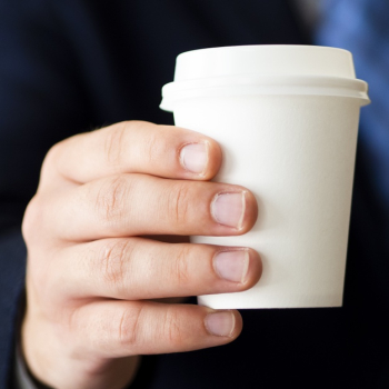 Close-up hand holding little coffee cup mock-up Free Photo