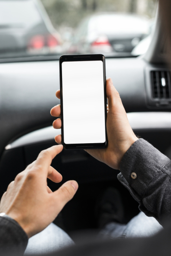 Close-up of a person's hand using mobile phone with white screen display