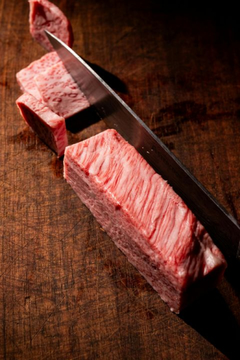 Close-up of Premium Wagyu Beef on Wooden Cutting Board Close-up of Premium Wagyu Beef on Wooden Cutting Board