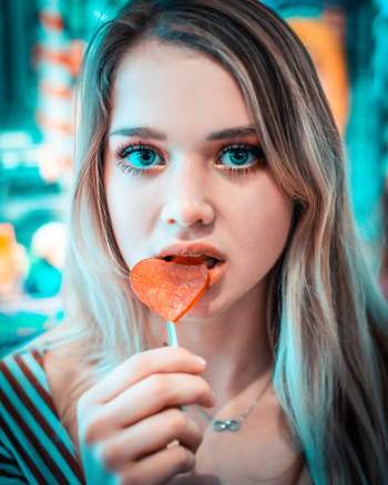 Close-Up Photo of a Woman Eating Lollipop Close-Up Photo of a Woman Eating Lollipop