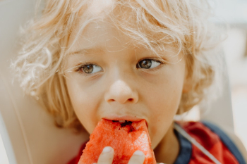 Close-Up Photo Of Boy Eating Watermelon Close-Up Photo Of Boy Eating Watermelon