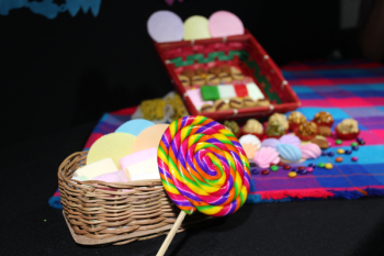 Close Up Photo of Lolipop Beside Woven Basket Close Up Photo of Lolipop Beside Woven Basket