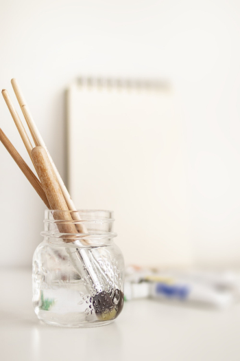 Close-Up Photo of Paintbrushes In Bottle