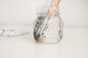 Close-Up Photo of Paintbrushes In Bottle