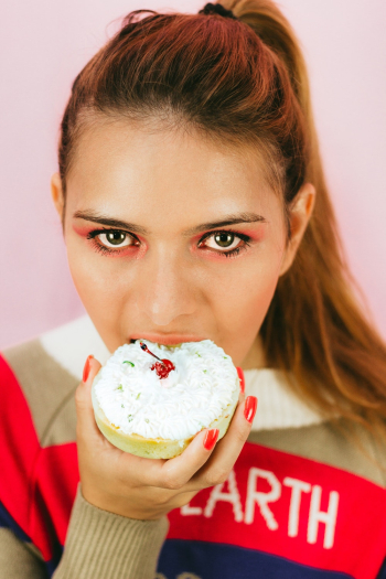 Close-up Photo of Woman Eating Pastry Close-up Photo of Woman Eating Pastry