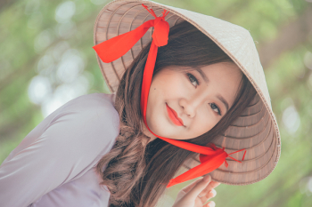 Close-Up Photography of a Woman Wearing Conical Hat