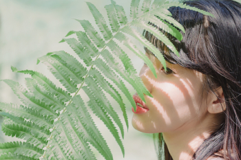 Close-Up Photography of Woman Near Fern Close-Up Photography of Woman Near Fern
