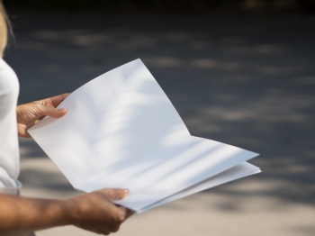 Close-up woman holding a mock-up magazine Free Photo