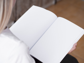 Close-up woman reading a mock-up magazine Free Photo