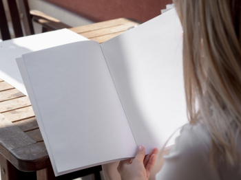 Close-up woman reading a mock-up magazine Free Photo