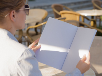 Close-up woman reading a mock-up magazine Free Photo