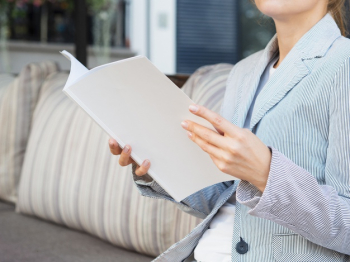 Close-up woman reading a mock-up magazine Free Photo