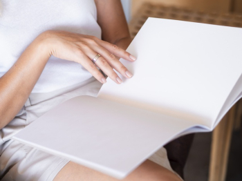 Close-up woman reading a mock-up magazine Free Photo