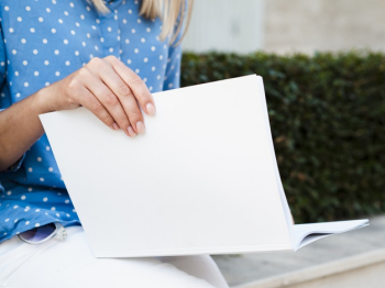 Close-up woman reading a mock-up magazine Free Photo