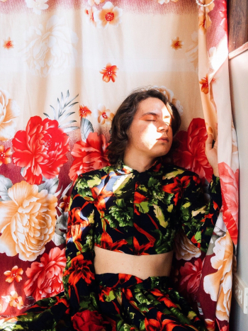 Closed Eyed Person Beside Floral Textile Closed Eyed Person Beside Floral Textile