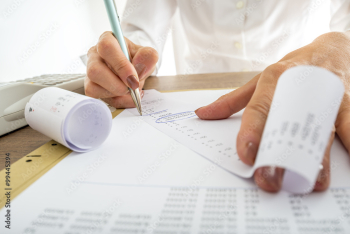 Closeup of female accountant looking through the receipts Closeup of female accountant looking through the receipts