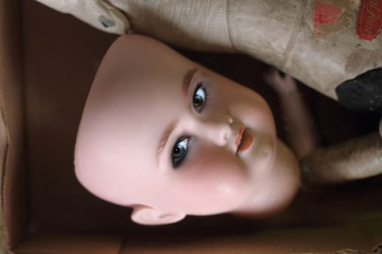 closeup photo of doll face closeup photo of doll face