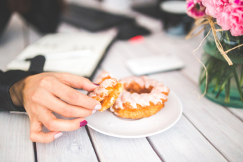 Closeup photo of hand choosing donut Closeup photo of hand choosing donut