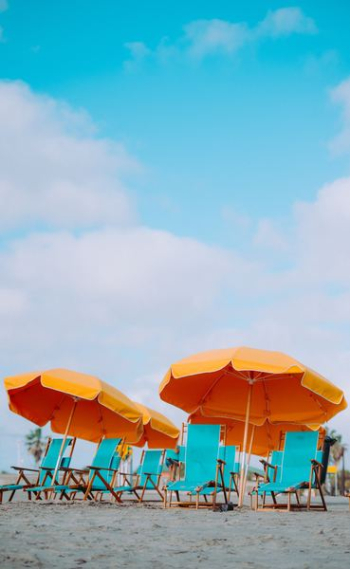 closeup photo of lounger chairs and beach umbrellas closeup photo of lounger chairs and beach umbrellas