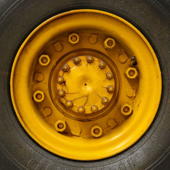 closeup photo of yellow vehicle wheel with tire closeup photo of yellow vehicle wheel with tire