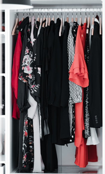Clothes Hanging in a Cabinet Clothes Hanging in a Cabinet