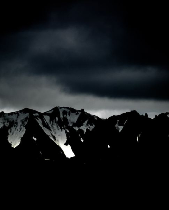 clouds over mountain range clouds over mountain range