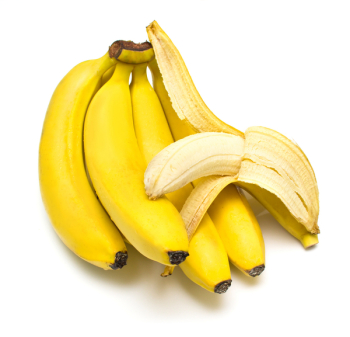 Cluster of ripe bananas. One banana is cleared away from a peel. Isolation, shallow DOF.