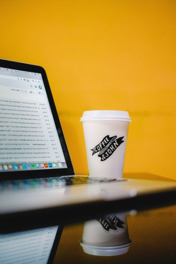 coffee & john-printed cup with lid beside MacBook coffee & john-printed cup with lid beside MacBook