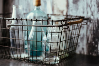Collection of bottles in metal mesh basket Collection of bottles in metal mesh basket