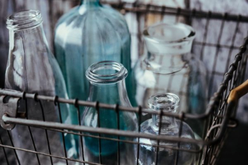 Collection of bottles in metal mesh basket Collection of bottles in metal mesh basket