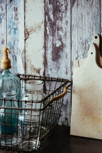 Collection of bottles in metal mesh basket Collection of bottles in metal mesh basket