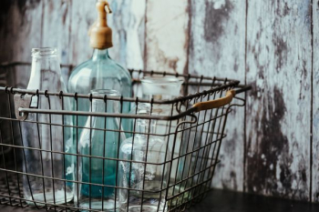 Collection of bottles in metal mesh basket Collection of bottles in metal mesh basket