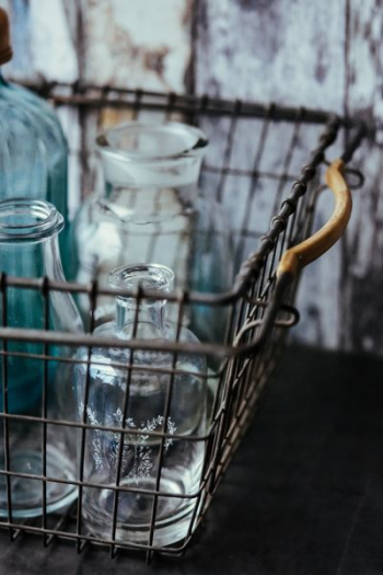 Collection of bottles in metal mesh basket Collection of bottles in metal mesh basket